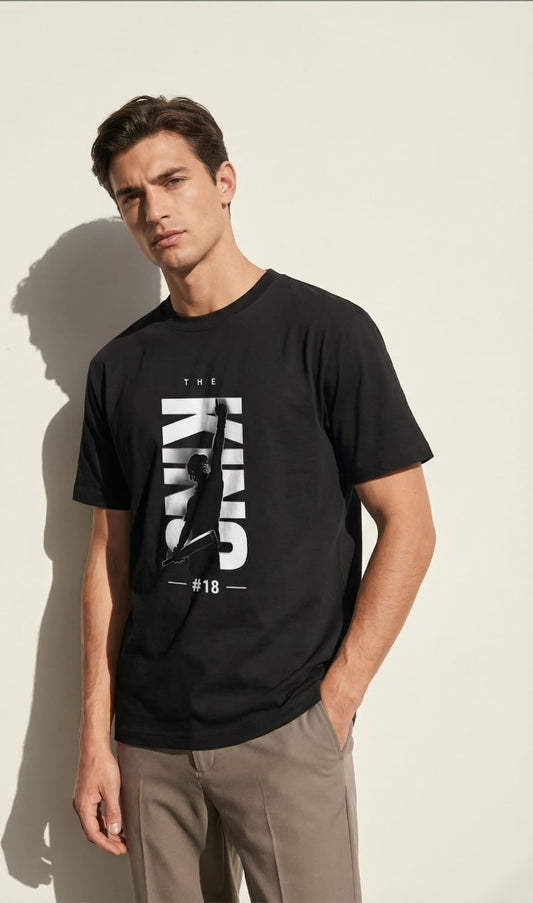 Man wearing a black t-shirt with white text against a beige background